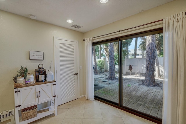 doorway to outside featuring light tile patterned flooring