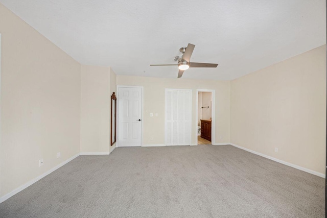 empty room with ceiling fan and light colored carpet