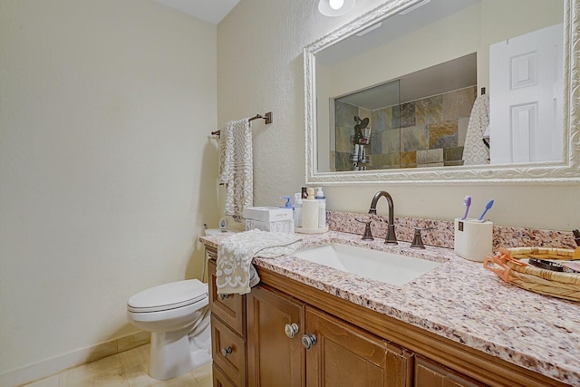 bathroom with toilet, vanity, tile patterned floors, and walk in shower