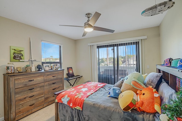 carpeted bedroom featuring access to exterior and ceiling fan