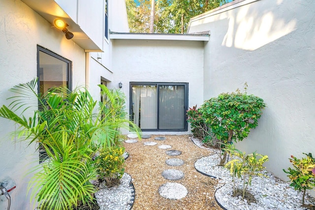 entrance to property featuring stucco siding