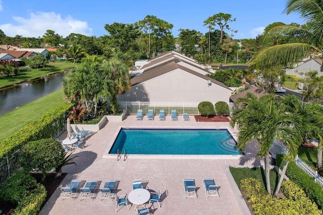 view of swimming pool featuring a water view and a patio area