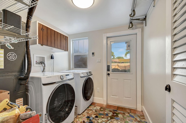 clothes washing area featuring separate washer and dryer and light tile patterned floors