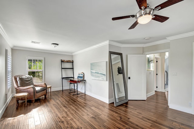 sitting room with dark hardwood / wood-style floors, ceiling fan, and crown molding