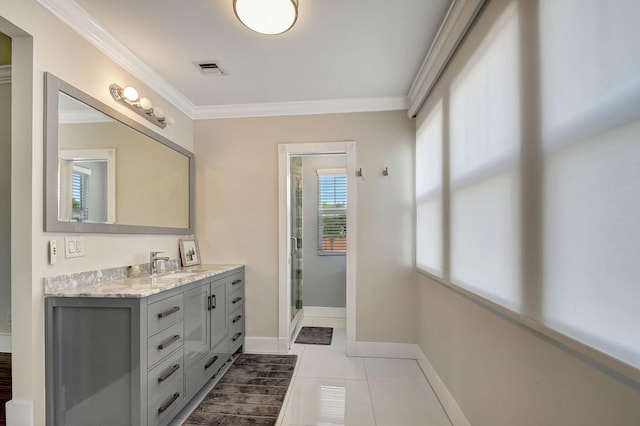 bathroom with tile patterned flooring, vanity, a shower with shower door, and ornamental molding