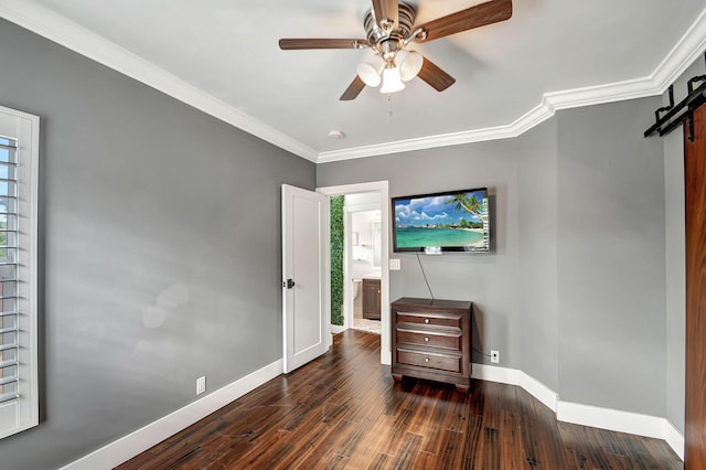 bedroom featuring ornamental molding, a barn door, ceiling fan, and dark wood-type flooring