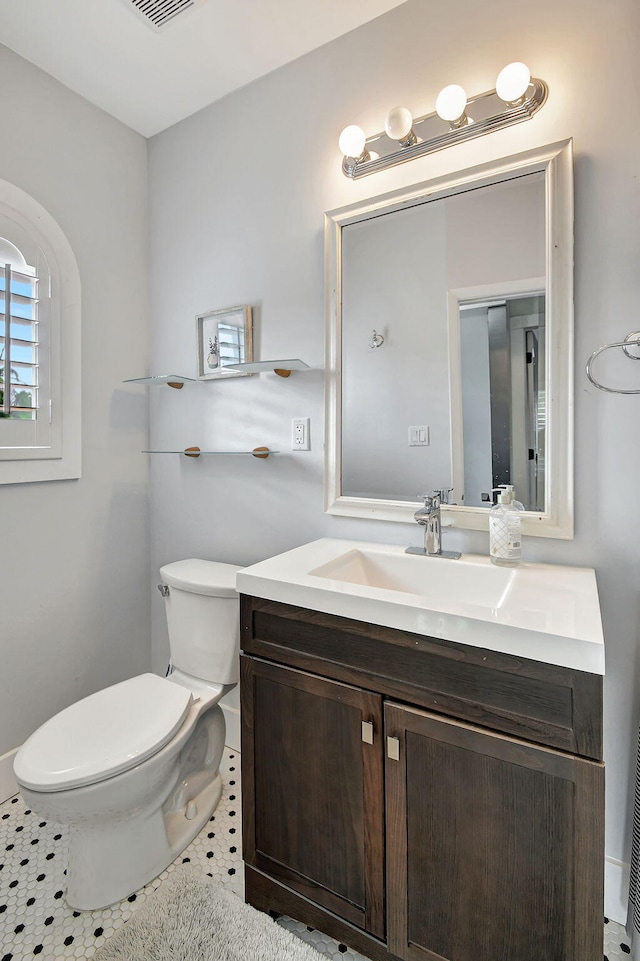 bathroom with tile patterned floors, vanity, and toilet