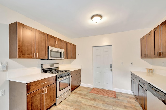 kitchen featuring stainless steel appliances and light hardwood / wood-style floors