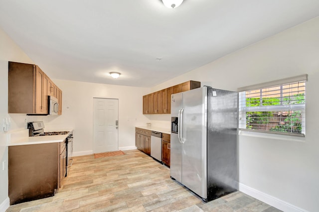 kitchen with light wood-type flooring and appliances with stainless steel finishes