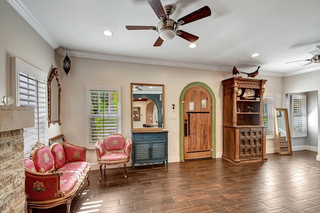 sitting room featuring a baseboard radiator, crown molding, and dark wood-type flooring