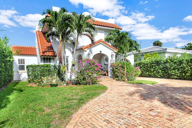 mediterranean / spanish house with a front yard