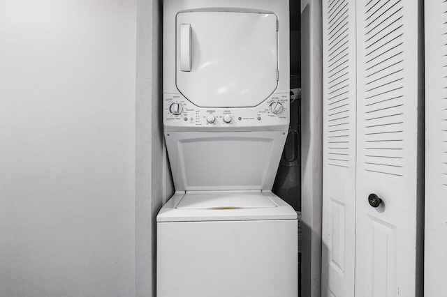 laundry area with stacked washing maching and dryer