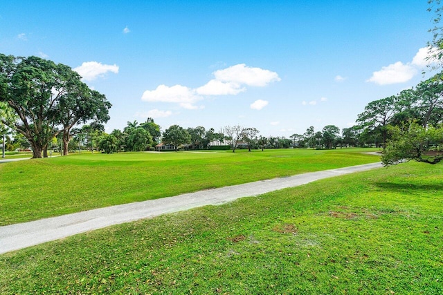 view of property's community with a lawn