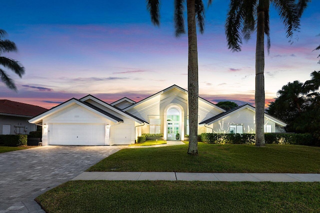 view of front of property featuring a yard and a garage