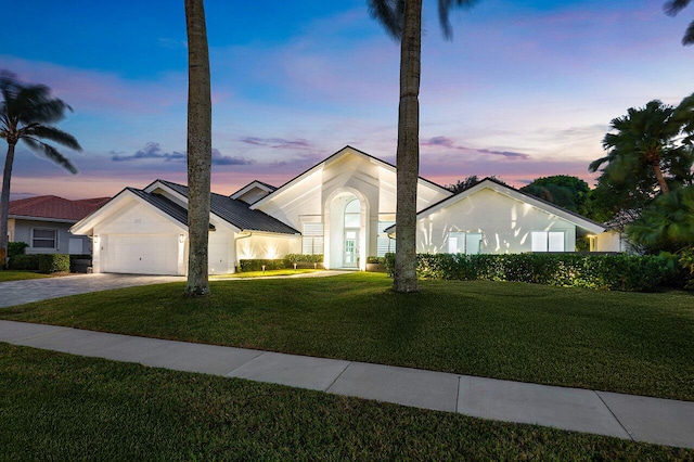 single story home with a lawn and a garage