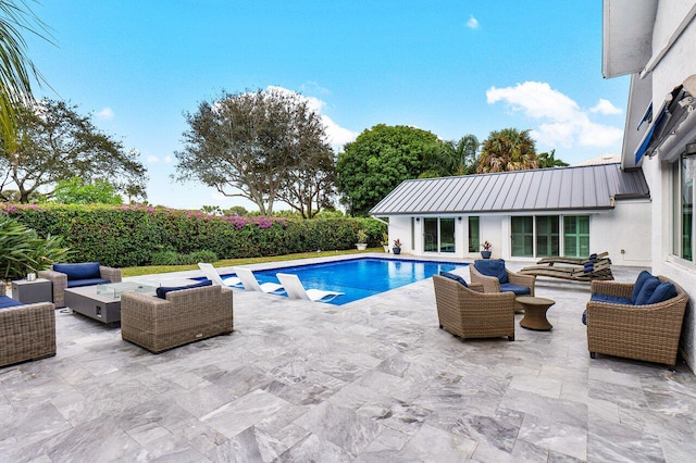 view of swimming pool with outdoor lounge area and a patio area