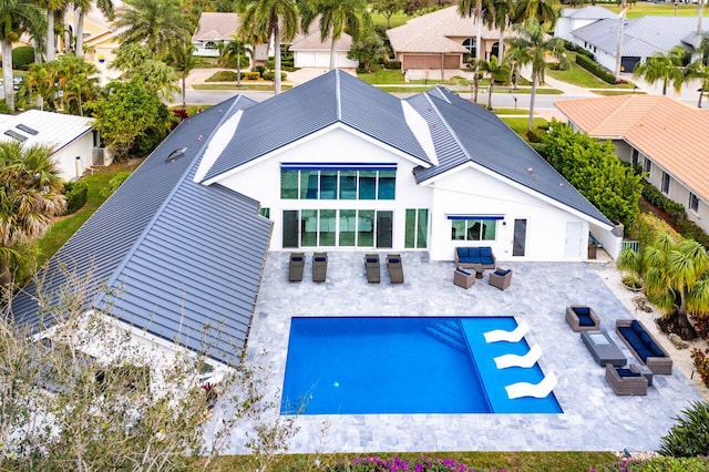 rear view of property featuring an outdoor hangout area