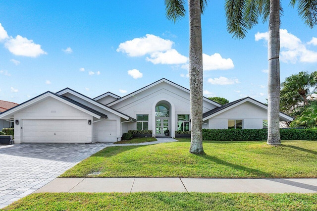 view of front of property with a garage and a front yard