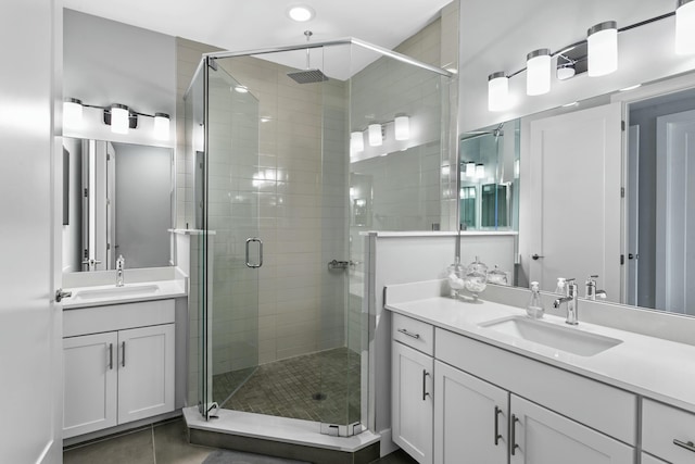 bathroom featuring tile patterned flooring, vanity, and a shower with shower door