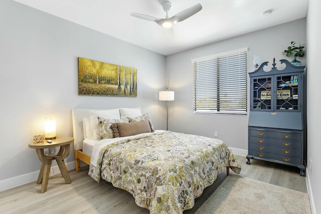 bedroom with ceiling fan and light hardwood / wood-style flooring