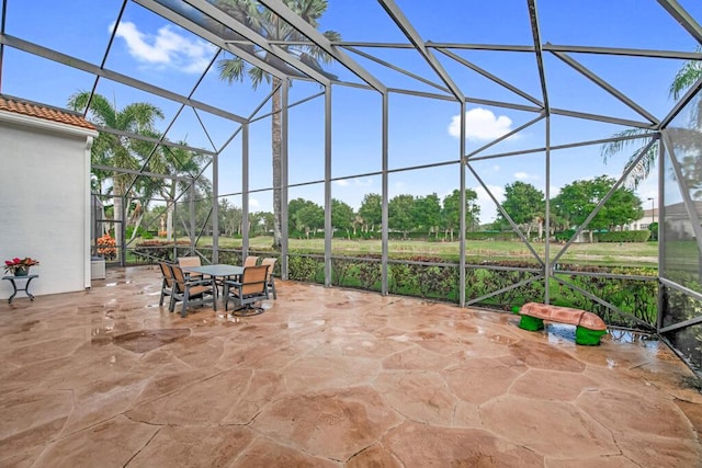 view of patio / terrace featuring glass enclosure