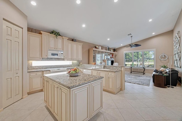 kitchen with ceiling fan, kitchen peninsula, cream cabinets, lofted ceiling, and white appliances