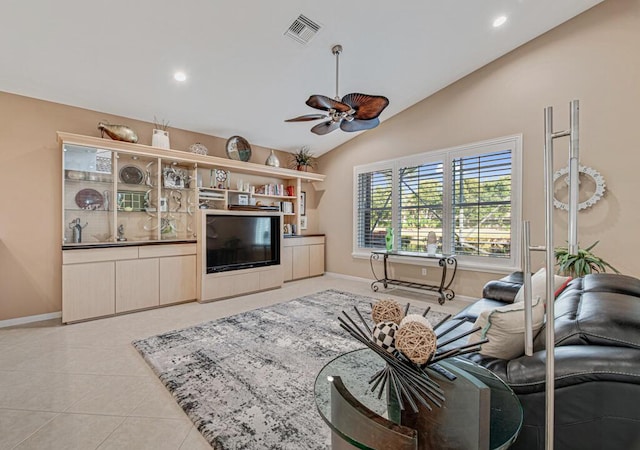 tiled living room featuring ceiling fan and lofted ceiling