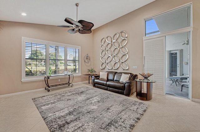 tiled living room featuring high vaulted ceiling and ceiling fan