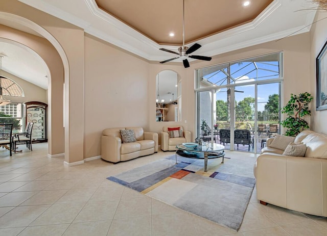 living room with light tile patterned floors, ceiling fan, and ornamental molding