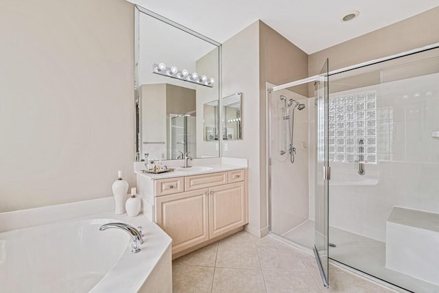 bathroom with tile patterned flooring, vanity, and separate shower and tub