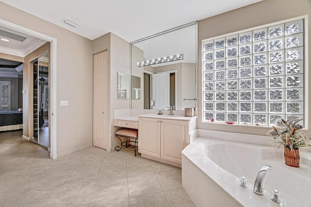 bathroom with tile patterned flooring, vanity, crown molding, and a tub