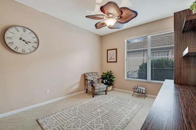 living area with ceiling fan and light tile patterned floors