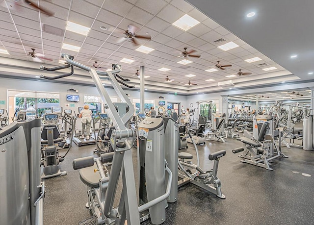 exercise room featuring a drop ceiling and ceiling fan