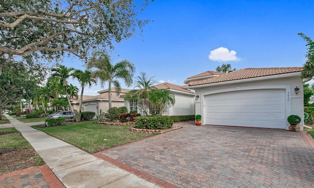 view of front of home featuring a front lawn and a garage