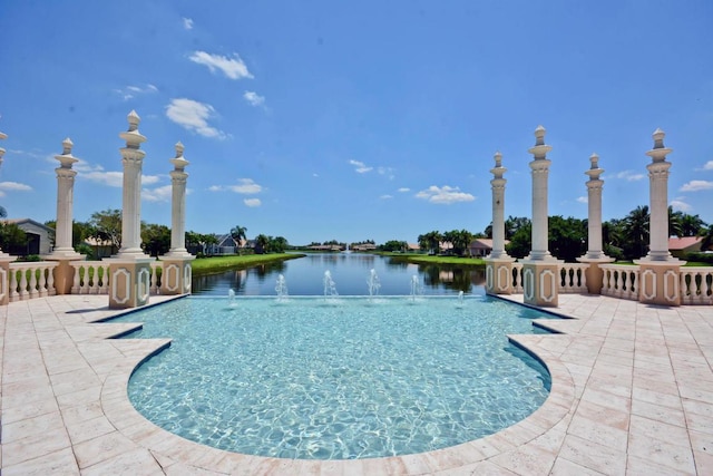 view of pool featuring a water view and a patio area