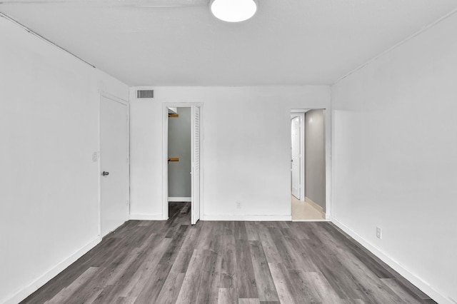 spare room featuring dark hardwood / wood-style flooring