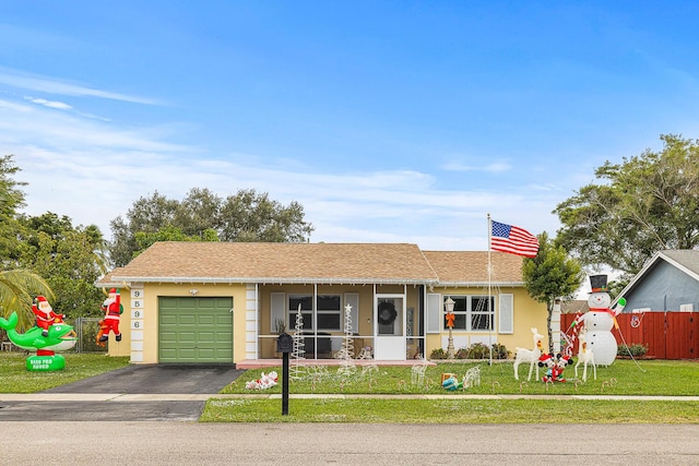 single story home with a garage and a front yard