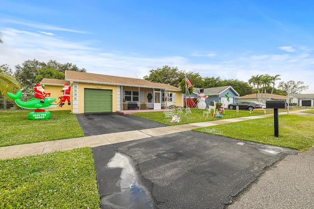 single story home with a front yard and a garage