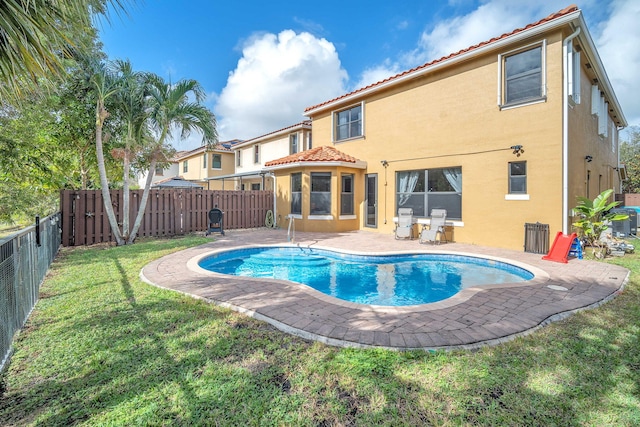 view of swimming pool featuring a yard, a sunroom, and a patio