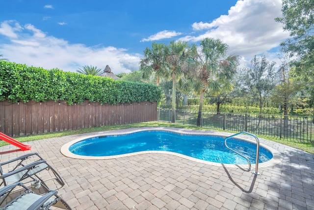 view of pool with a fenced in pool, a fenced backyard, and a patio area