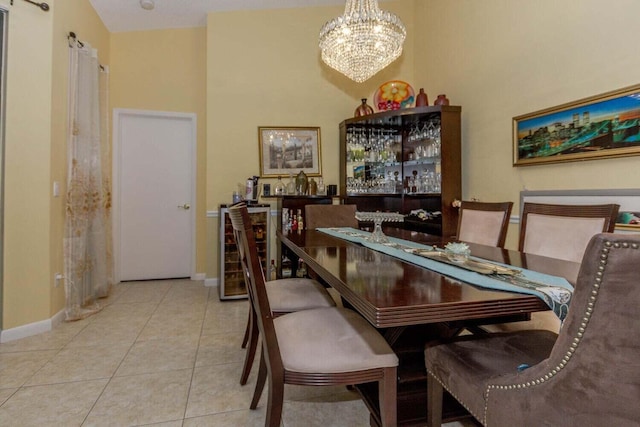 dining room with a high ceiling, light tile patterned flooring, wine cooler, and a chandelier