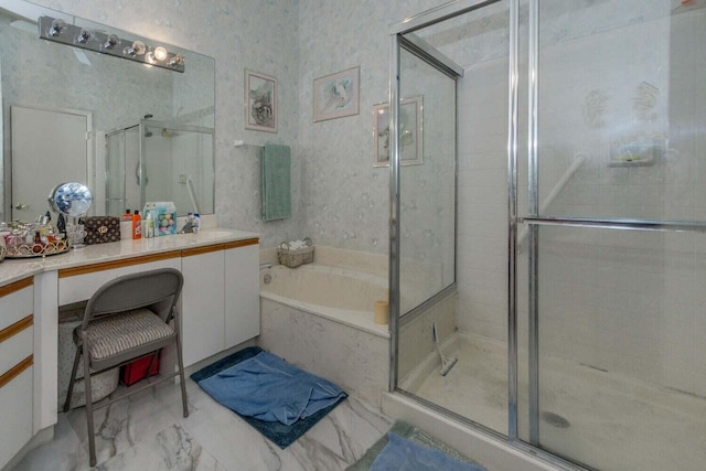 bathroom with vanity and shower with separate bathtub