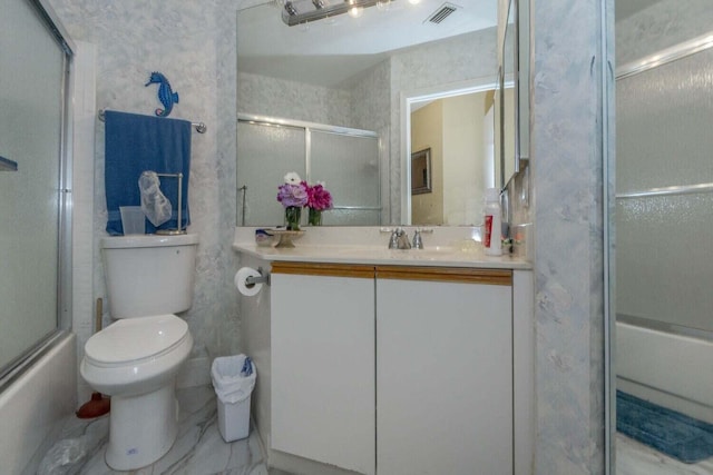 full bathroom with vanity, bath / shower combo with glass door, and toilet