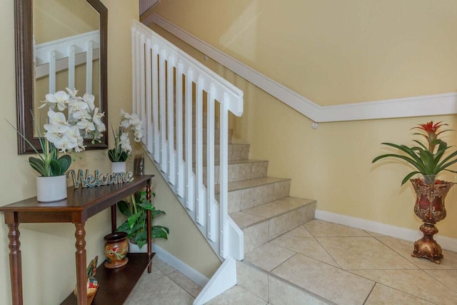 stairway with tile patterned floors