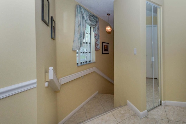 hall featuring light tile patterned flooring