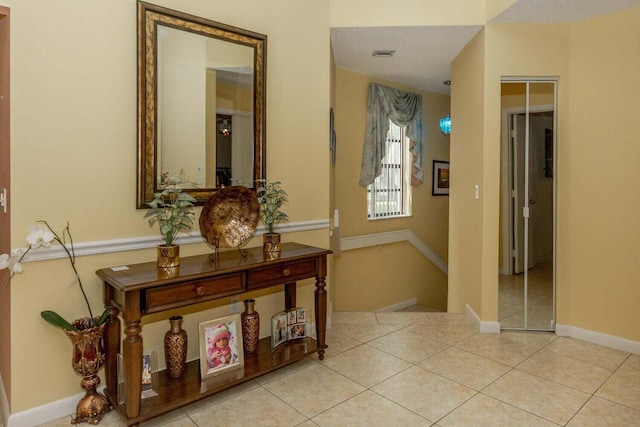 hall featuring light tile patterned floors