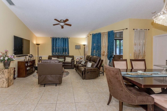 living room with lofted ceiling, light tile patterned floors, a textured ceiling, and ceiling fan