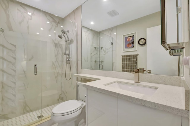 bathroom with a shower with door, vanity, and toilet