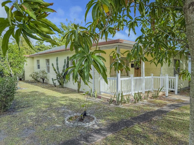 view of side of property featuring covered porch