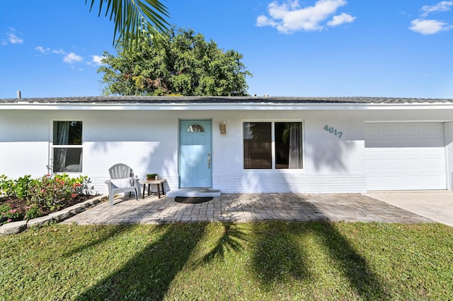 exterior space with a garage and a front lawn